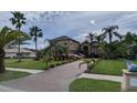 Beautiful home with a paver driveway, mature landscaping, and well-manicured lawn at 10532 Cory Lake Dr, Tampa, FL 33647
