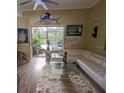 Living room featuring comfortable seating, a glass coffee table, and views of the outdoor pool area at 10532 Cory Lake Dr, Tampa, FL 33647