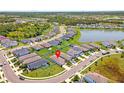 Expansive aerial view showcasing a vibrant neighborhood with lush greenery, ponds, and well-maintained landscaping at 10945 High Noon Trl, Parrish, FL 34219