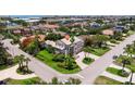 Beautiful aerial view of a large home with lush landscaping, a circular driveway, and a welcoming facade at 1156 2Nd S Ave, Tierra Verde, FL 33715