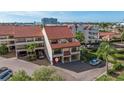 Exterior of a condo featuring a red tile roof, private garage, and well-maintained landscaping at 120 1St E St # 109, Tierra Verde, FL 33715