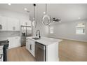 Modern kitchen featuring an island with a sink, stainless steel appliances, and pendant lighting at 1625 39Th S St, St Petersburg, FL 33711