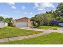 Well-maintained single-story home with lush front lawn and a spacious two-car garage at 1944 Hastings Ln, Clearwater, FL 33763