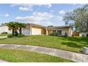 Lovely single-story home featuring lush lawn and a two-car garage at 1944 Hastings Ln, Clearwater, FL 33763