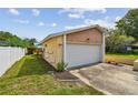 Spacious two-car garage with shingle detailing above and green lawn at 1944 Hastings Ln, Clearwater, FL 33763
