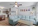 Open living room features a comfortable blue sectional couch and an open floorplan connected to the kitchen at 2136 Cunningham Dr, Clearwater, FL 33763