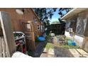 Backyard area with storage shed, cluttered yard and overgrown vegetation, indicating need for landscaping and cleanup at 3424 16Th E St, Bradenton, FL 34208