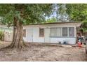 Modest single-story home with a tree in the front and a covered porch at 3424 16Th E St, Bradenton, FL 34208