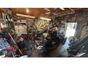 Garage interior cluttered with tools, motorcycles, and equipment, showcasing storage and workshop space at 3424 16Th E St, Bradenton, FL 34208