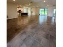 Spacious open-concept living area with tile flooring, recessed lighting, and sliding glass doors at 3504 Crooked River Dr, Plant City, FL 33565