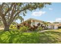 Well-maintained home showcasing a manicured lawn, vibrant landscaping, walkway, and an attached two-car garage at 3966 High Bluff Dr, Largo, FL 33770