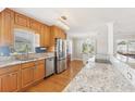 Bright kitchen featuring granite countertops, stainless steel appliances, hardwood floors, and ample natural light at 3966 High Bluff Dr, Largo, FL 33770