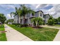 View of the townhome property showcasing the lawn and landscaping at 4023 Wild Senna Blvd, Tampa, FL 33619