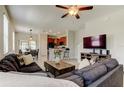 Comfortable living room featuring a ceiling fan and open access to the kitchen at 4023 Wild Senna Blvd, Tampa, FL 33619