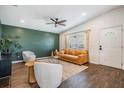 Cozy living room with stylish furniture, including a leather sofa and plush chairs over hardwood floors at 4205 N Suwanee Ave, Tampa, FL 33603
