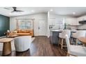 Open-concept space featuring a modern living room seamlessly connected to an elegant white kitchen at 4205 N Suwanee Ave, Tampa, FL 33603