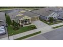Beautiful house with a manicured lawn and a pond view at 4239 Woodland Retreat Blvd, New Port Richey, FL 34655