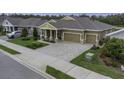 Attractive single-story home featuring a spacious driveway and lush landscaping at 4239 Woodland Retreat Blvd, New Port Richey, FL 34655