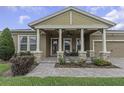 Inviting covered porch with stone pillars and comfortable seating area at 4239 Woodland Retreat Blvd, New Port Richey, FL 34655