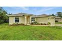 Well-maintained single-Gathering home with a lush green lawn and tidy landscaping at 5153 Bayley St, North Port, FL 34288