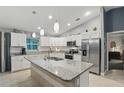 Spacious kitchen featuring white cabinets, granite countertops and stainless-steel appliances at 5153 Bayley St, North Port, FL 34288
