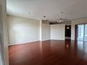 Spacious living area featuring hardwood floors, ceiling fan, and neutral paint at 6213 Ashfield Pl, Wesley Chapel, FL 33545
