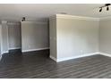 Spacious living room featuring gray walls, white crown molding, and luxury vinyl plank flooring at 639 48Th N Ave, St Petersburg, FL 33703