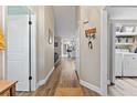Inviting hallway with wood floors, leading to an open-concept kitchen and laundry area at 6521 69Th N Ave, Pinellas Park, FL 33781