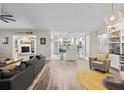 Spacious living room with modern furnishings, fireplace, and open access to the bright kitchen at 6521 69Th N Ave, Pinellas Park, FL 33781
