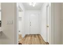 Bright foyer features wood floors, a white front door and a hall closet at 800 S Dakota Ave # 204, Tampa, FL 33606