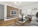 Stylish living room features an accent wall, modern lighting, and wood floors at 800 S Dakota Ave # 204, Tampa, FL 33606