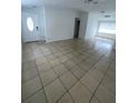 View of the spacious living room featuring tile flooring, white walls and lots of natural light at 9106 Telford Ct, Tampa, FL 33615