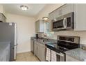 Modern kitchen featuring stainless steel appliances and gray cabinets at 920 York Dr, Brandon, FL 33510