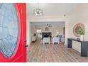 Bright entryway showcasing an open-concept design with wood floors, fireplace, and stylish decor at 100 E Fern St, Tampa, FL 33604