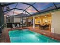 Inviting screened-in pool and patio area perfect for outdoor dining and lounging with serene backyard views at 1111 Jasmine Creek Ct, Sun City Center, FL 33573