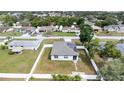 Aerial view of a single-Gathering home with solar panels, surrounded by a well-maintained yard and white fence at 11123 Thornberry Dr, Spring Hill, FL 34609