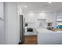 Beautiful white kitchen with stainless steel appliances, white cabinetry, and modern countertops at 11720 80Th Ave, Seminole, FL 33772
