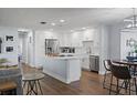 Modern white kitchen featuring stainless steel appliances, quartz countertops, and a central island at 11720 80Th Ave, Seminole, FL 33772