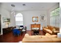 Bright living room with wood floors, a decorative table with mirror, and comfortable leather couches at 11821 Easthampton Dr, Tampa, FL 33626