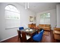 Bright living room with wood floors, a decorative table with mirror, and comfortable leather couches at 11821 Easthampton Dr, Tampa, FL 33626
