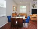 Bright living room with wood floors, a decorative table with mirror, and comfortable leather couches at 11821 Easthampton Dr, Tampa, FL 33626