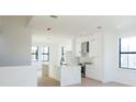 Spacious, modern kitchen with white cabinets, marble island, and stainless steel appliances at 1218 E Kay St # 24, Tampa, FL 33602