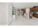 Open-concept layout featuring tile flooring and seamless flow between the living room, kitchen, and patio at 13311 Dorado Shores Ave, Riverview, FL 33579
