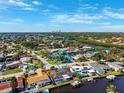 Stunning aerial view showcasing waterfront property with a pool and boat dock at 1399 49Th Ne Ave, St Petersburg, FL 33703