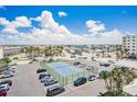 Aerial view of the condo complex featuring the parking lot and tennis courts, near the beautiful community at 17500 Gulf Blvd # 407, Redington Shores, FL 33708