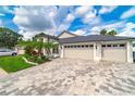 Beautifully maintained home featuring a spacious paver driveway leading to a three car garage at 18504 Country Crest Pl, Tampa, FL 33647