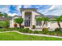 Charming home showcasing a well-manicured lawn and exquisite landscaping around the large front entry at 18504 Country Crest Pl, Tampa, FL 33647