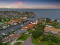 Aerial view of a neighborhood with waterfront homes, boat docks, and canals leading to a large body of water at 1931 Kentucky Ne Ave, St Petersburg, FL 33703