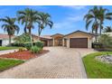 Beautiful single story home featuring a tile roof, double door entryway and a circular brick driveway with lush landscaping at 1931 Kentucky Ne Ave, St Petersburg, FL 33703
