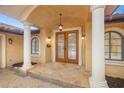 Covered home entry with double doors, tile flooring, and decorative sconces at 1931 Kentucky Ne Ave, St Petersburg, FL 33703